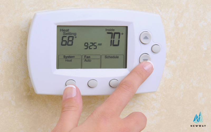 Tehnician calibrating thermostat during AC service